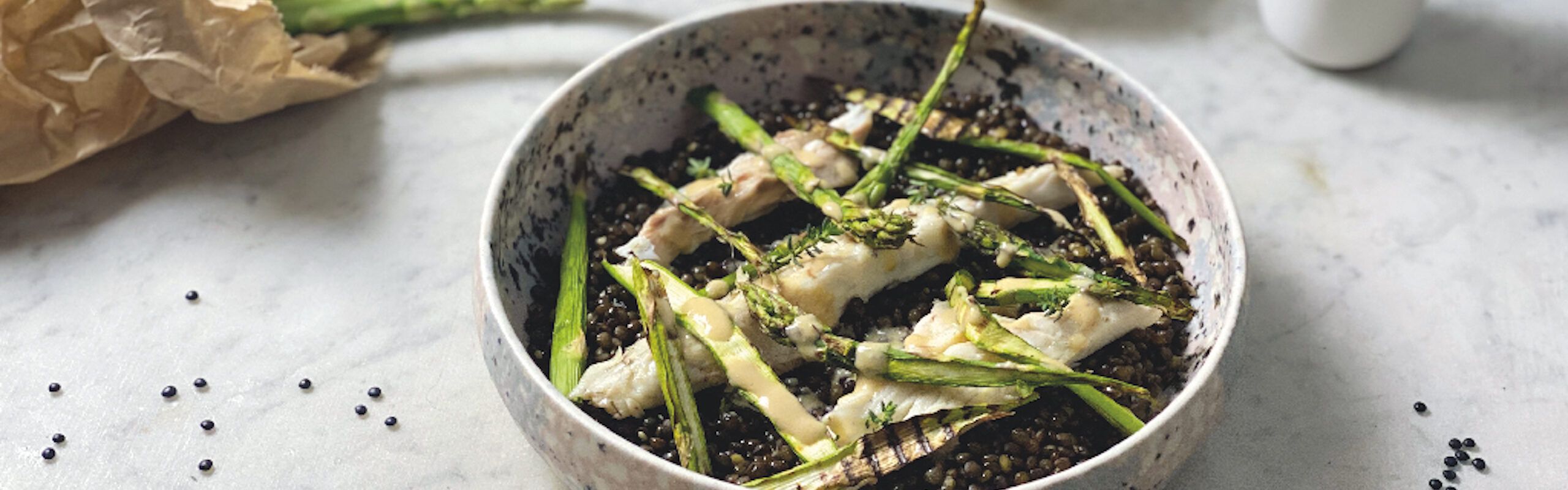 Sea bass with asparagus and black beluga lentils